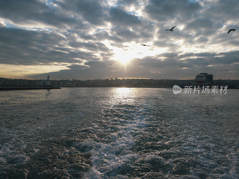 City lines ship departing from Istanbul Kadıköy pier at sunrise